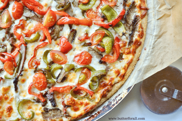 A sourdough and masa harina cornmeal pizza crust topped to perfection with steak, peppers and tomatoes.