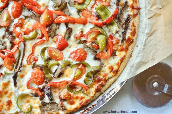 A sourdough and masa harina cornmeal pizza crust topped to perfection with steak, peppers and tomatoes.