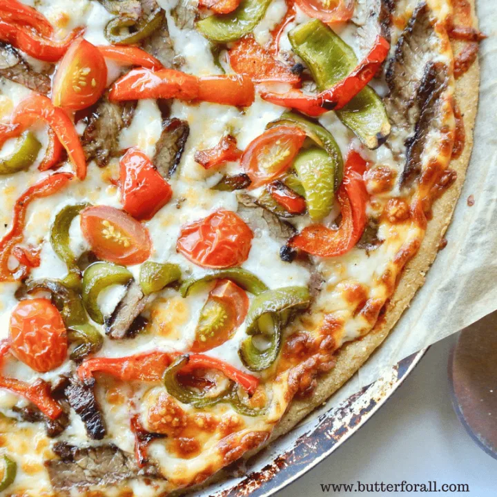 A sourdough and masa harina cornmeal pizza crust topped to perfection with steak, peppers and tomatoes.