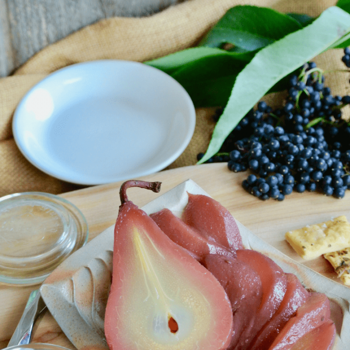 Beautiful elderberry poached pears and elderberry syrup compliment this cheese and meat board.