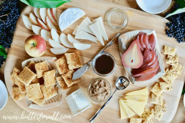 A beautiful cheese and potted meat board featuring elderberry poached pears.