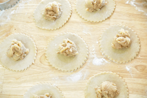 Each mini pie is filled with cooked maple apple filling.