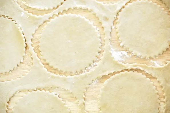 Sourdough pie crust is rolled and cut.