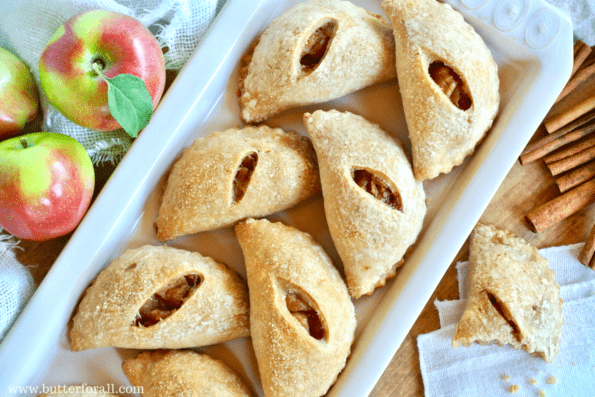 A plate full of mini maple apple pies.