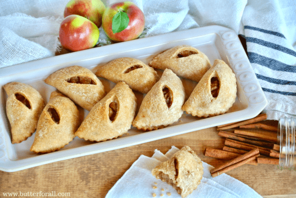 A long tray of mini maple apple pies.