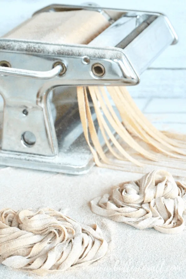 Cutting sourdough noodles in a pasta machine.