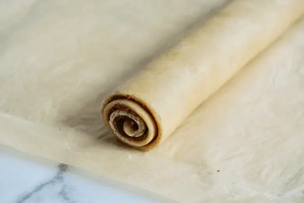 A sealed cylinder of cranberry and sourdough pastry.