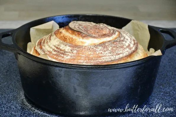 An artisan sourdough boule baked in a Dutch oven.