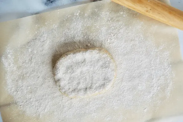 Preparing the sourdough pastry for rolling.