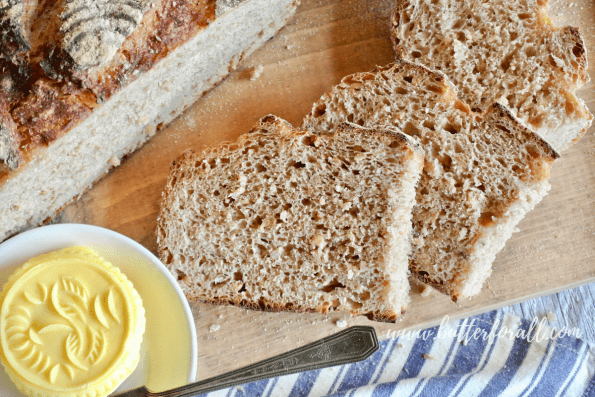 Soft slices of whole grain sourdough await real raw butter.