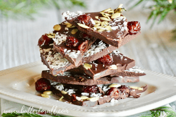 This special raw chocolate bark is sweetened with raw honey and topped with dried cranberries, nutty coconut and salty sprouted pumpkin seeds. Give it as a gift or share it with your family and friends. You can't go wrong with this real food chocolate bark that is a healthy as it is beautiful!