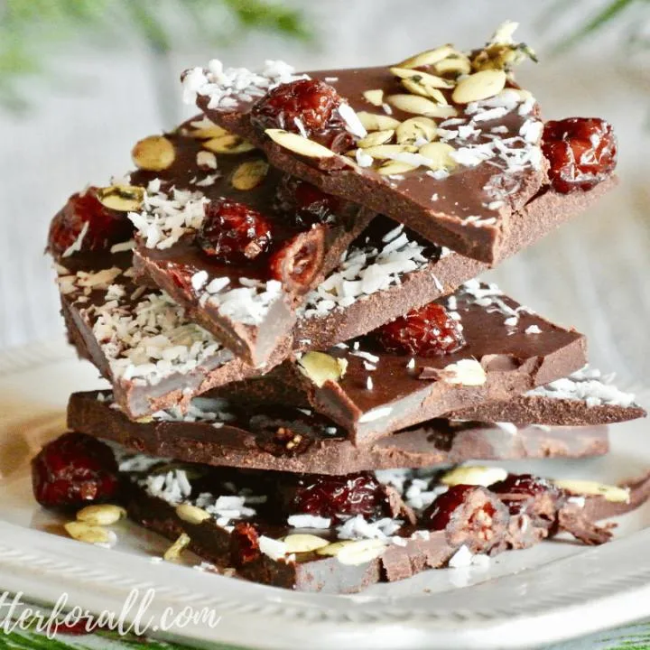 This special raw chocolate bark is sweetened with raw honey and topped with dried cranberries, nutty coconut and salty sprouted pumpkin seeds. Give it as a gift or share it with your family and friends. You can't go wrong with this real food chocolate bark that is a healthy as it is beautiful!
