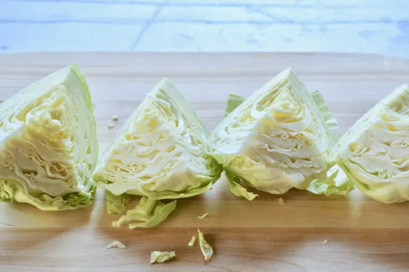 The cabbage is cut into equal quarters.