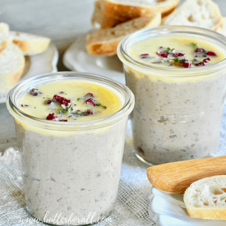 Pots of Cranberry Apple Duck Liver Pâté served with fresh sourdough baguette.