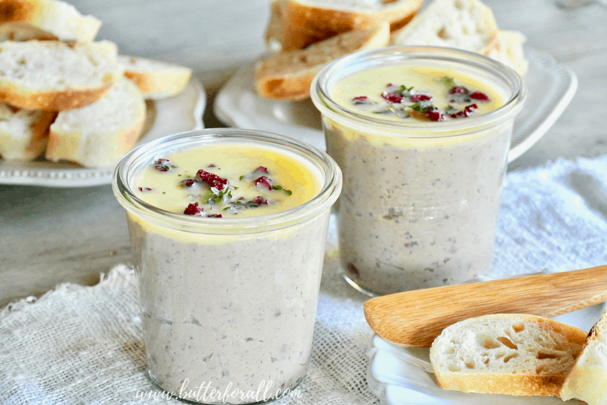 Pots of Cranberry Apple Duck Liver Pâté served with fresh sourdough baguette.