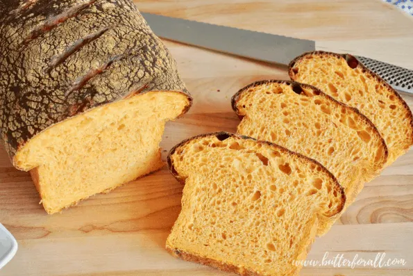 A sliced sweet potato sourdough loaf showing the soft open crumb.