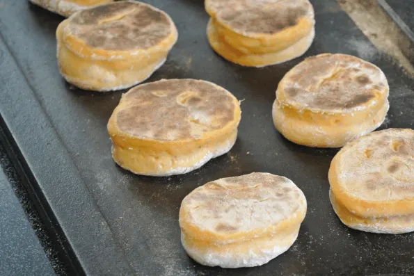 Cooking the English muffins on the second side until done.