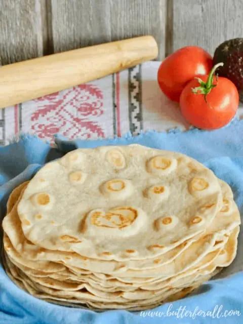 A plate of hot and fresh sourdough tortillas made with real lard and fermentation. 