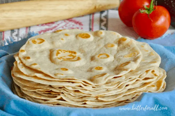 A stack of warm fresh sourdough tortillas made with pastured lard, whole wheat flour and traditionally fermented for better digestibility!