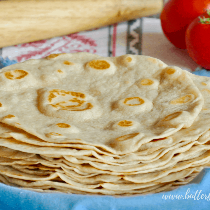 A stack of warm fresh sourdough tortillas made with pastured lard, whole wheat flour and traditionally fermented for better digestibility!