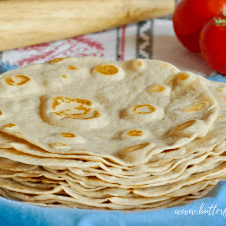 A stack of warm fresh sourdough tortillas made with pastured lard, whole wheat flour and traditionally fermented for better digestibility!