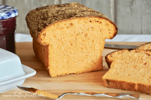 A loaf of sweet potato sourdough bread with a gorgeous orange color.