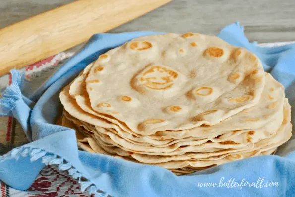 A tall stack of sourdough tortillas made in the traditional style with pastured lard.