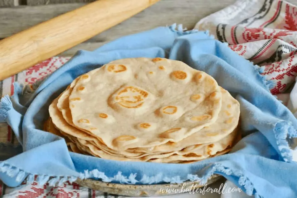 A plate of warm homemade sourdough tortillas just waiting for your favorite toppings.