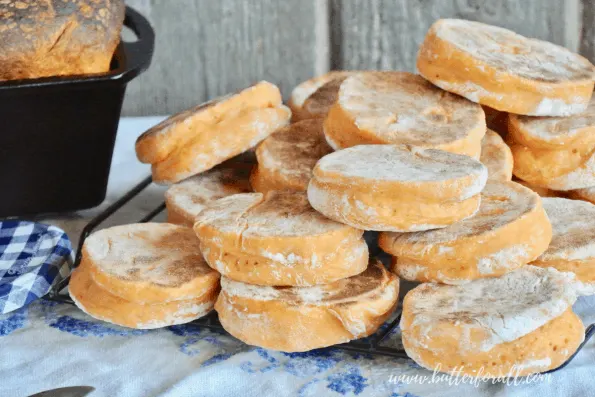 A big pile of fresh baked sweet potato sourdough English muffins!