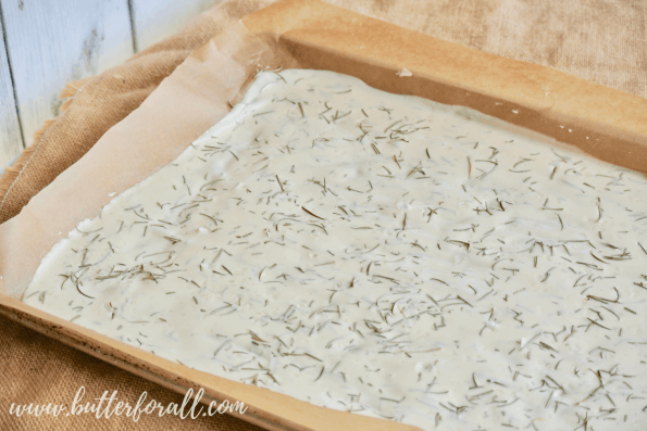 A pan filled with sourdough discard cracker batter is ready for the oven. 