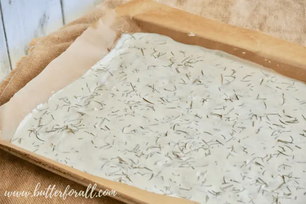 A pan filled with sourdough discard cracker batter is ready for the oven. 