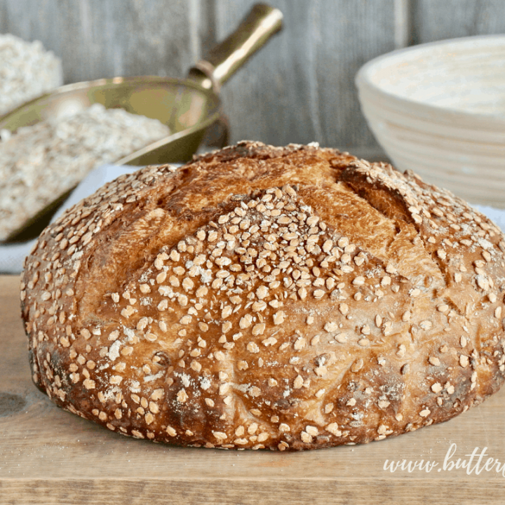 A perfect loaf of sweet and soft Honey Oat Sourdough awaits being cut and devoured.