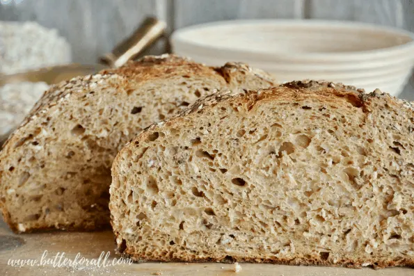 Cutting into the crumb of this Honey Oat Sourdough reveals a light and airy texture!