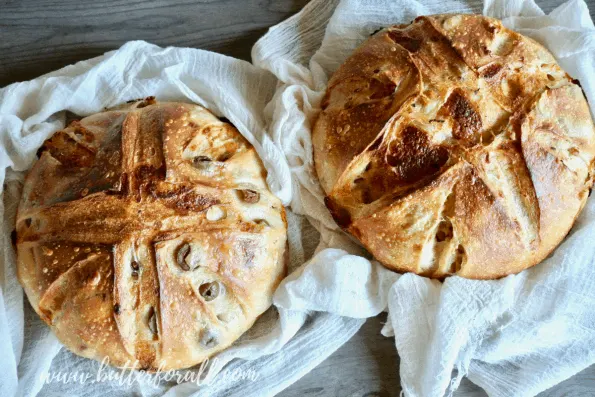 Two cheesy sourdough pizza bread loaves.