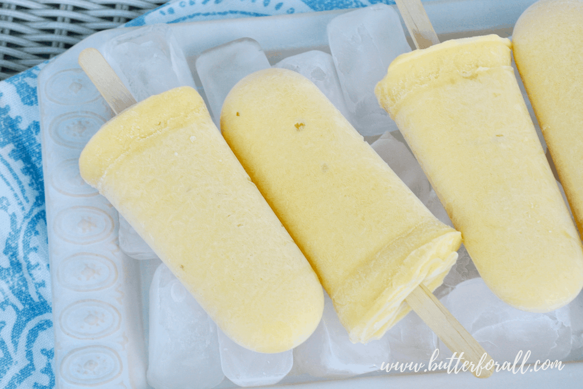 Summer is the season for popsicles. Make them right with probiotic Coconut Yogurt, fresh fruit, and unrefined sweetener! #realfood #fermented #probiotic #mangolassi #dairyfree #coconut #healthyfat #nourishing #wisetraditions #summer #Popsicles #fruit #yogurt
