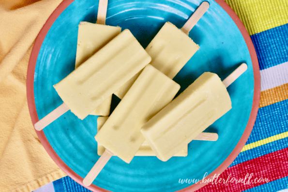 A colorful plate of mango lassi popsicles.