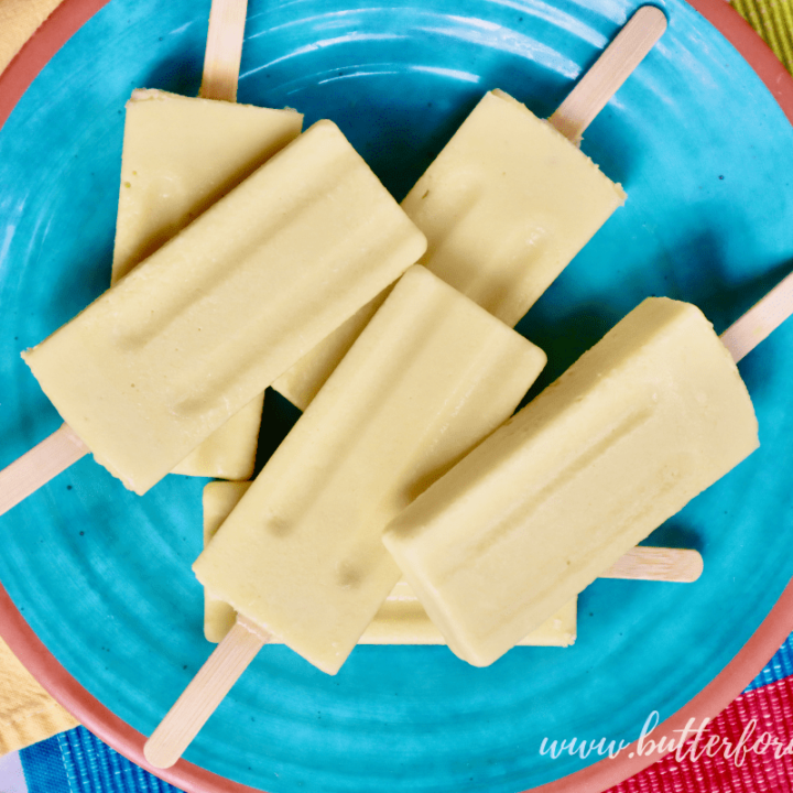 A colorful plate of mango lassi popsicles.