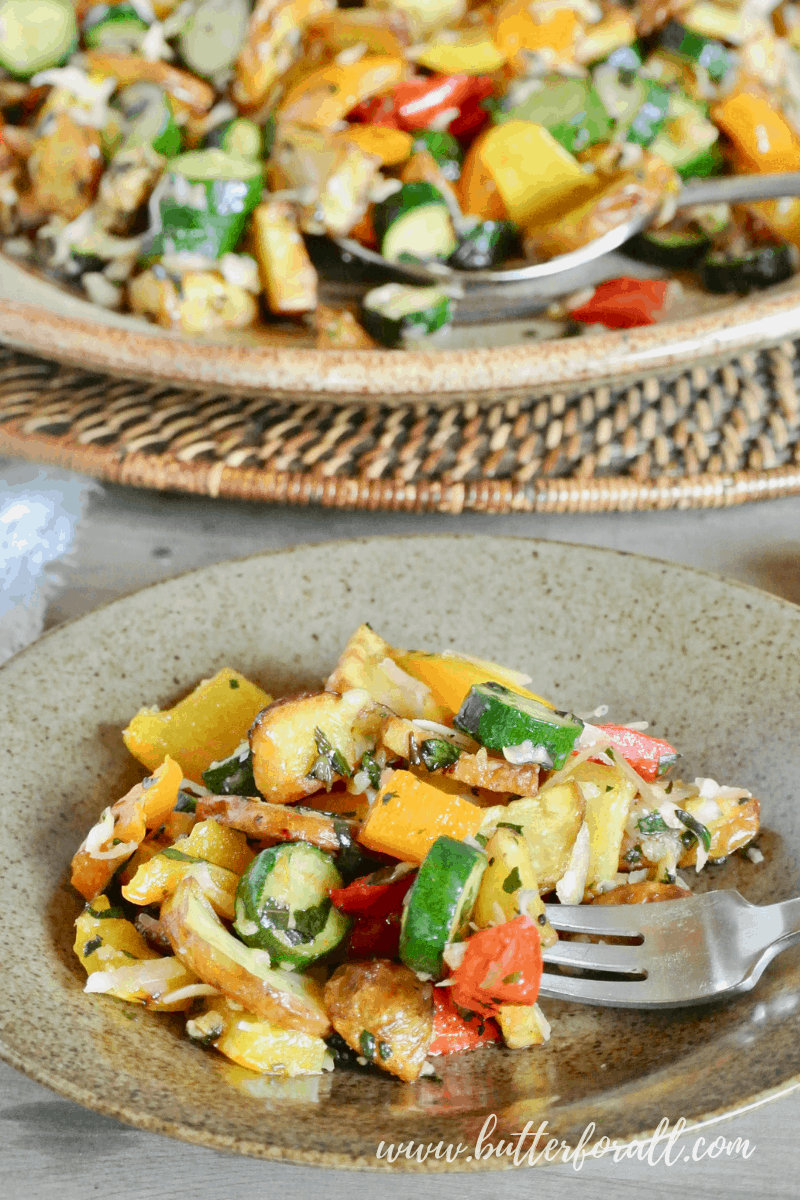 The colors and flavors of these easy sheet-pan roasted summer vegetables speak for themselves! #realfood #onepan #easy #summer #potluck #potatoes #squash #peppers #herbs #parmesan #basil #sidedish #entertaining