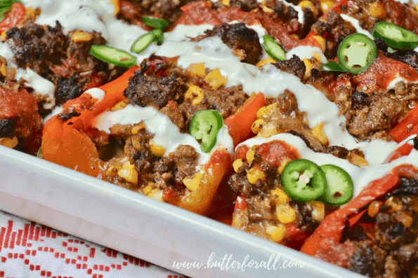 A close-up of a pan of baked stuffed peppers.