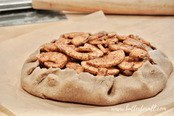 Folding the apple galette crust over the filling.