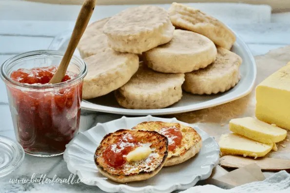 Stacks of English muffins spread with jam and butter.