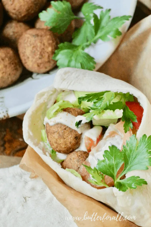 A pita stuffed with fried falafel balls, tahini, and veggies.