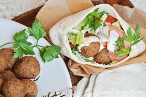 A pita stuffed with fried falafel balls, tahini, and veggies.