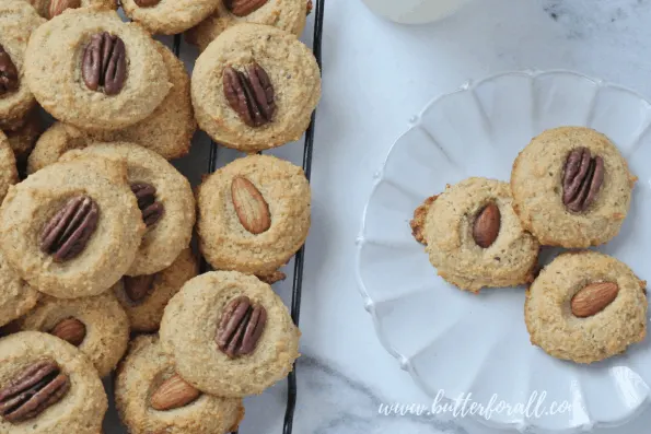 A plate of grain-free cookies topped with nuts.