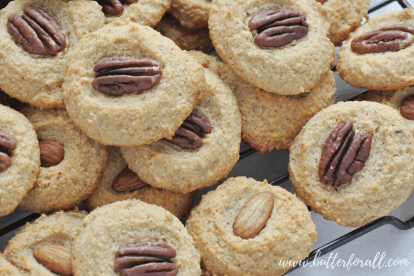 A close-up of grain-free cookies topped with nuts.