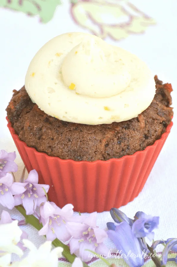 A close-up of a coconut honey buttercream frosted cupcake.