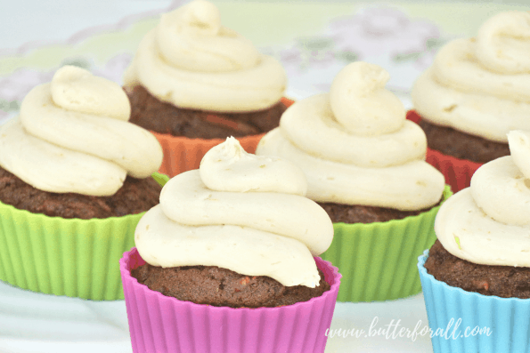 A tray of coconut honey buttercream frosted cupcakes.