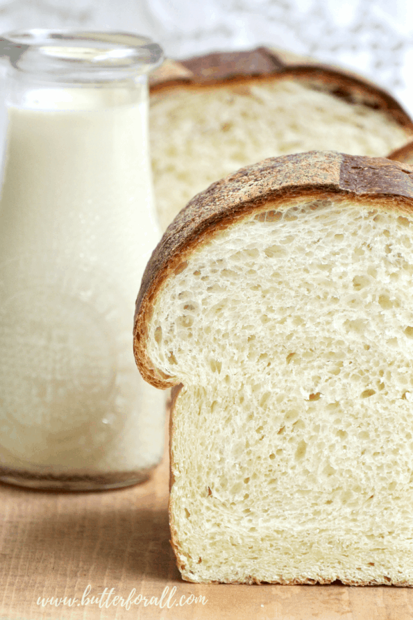 A close-up of a loaf of sliced sourdough milk bread.