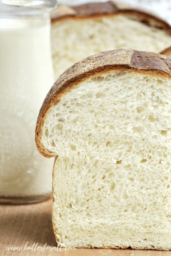 A close-up of a loaf of sliced sourdough milk bread.