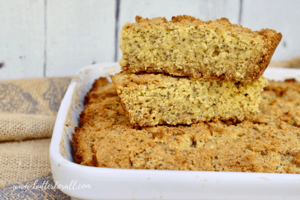 A pan of blueberry-free cornbread with cut pieces on top.